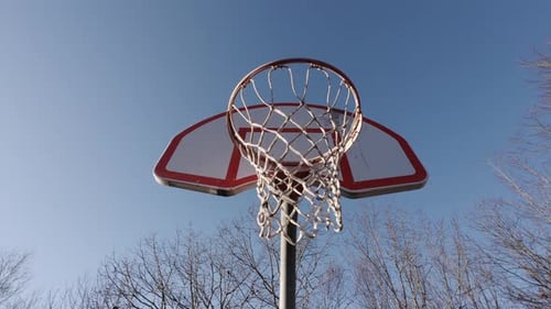 Outdoor Basketball Shot Flying Into Hoop Scoring On Court In Park