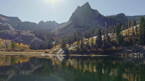 Aerial drone shot of Lake Blanche in Utah’s Big Cottonwood Canyon. The camera dollys out, showing go