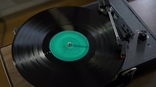 Black Vinyl Retro with Turquoise Color Screen in Center Record on DJ Turntable