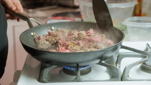 Ground Meat Cooking in a Pan on Stove