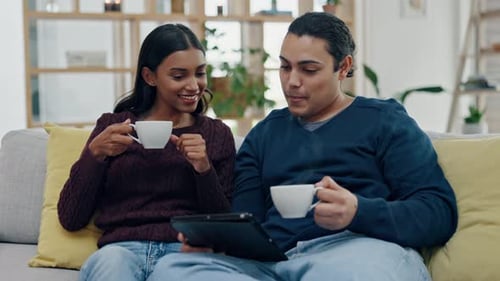 Couple Relaxing at Home with Coffee and Tablet