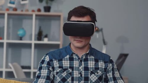 User is Immersed in and Thoroughly Enjoying a Captivating Virtual Reality Experience Indoors