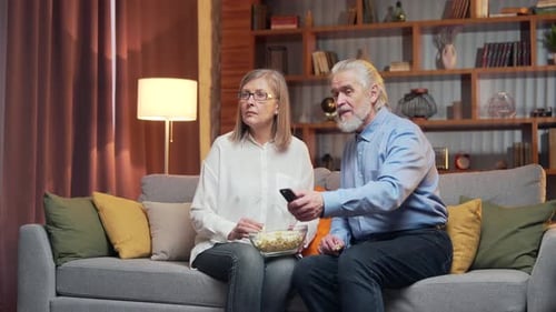 Adult Couple Relaxing and Watching Television at Home