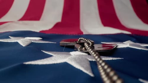 Military Dog Tags on American Flag Close Up