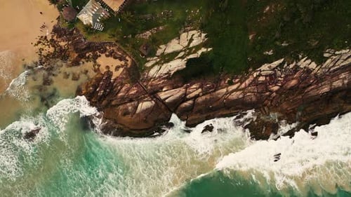 Aerial view of a summer seascape beach, beautiful waves, blue water at sunset. Top view from drone