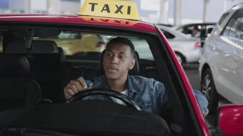 Man in Taxi Talking in Parking Garage