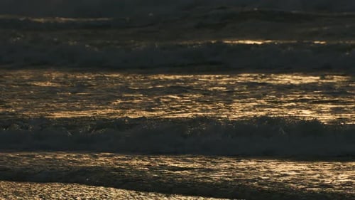 Beautiful sea waves and sand close up texture at tropical beach during golden sunset, high quality 4