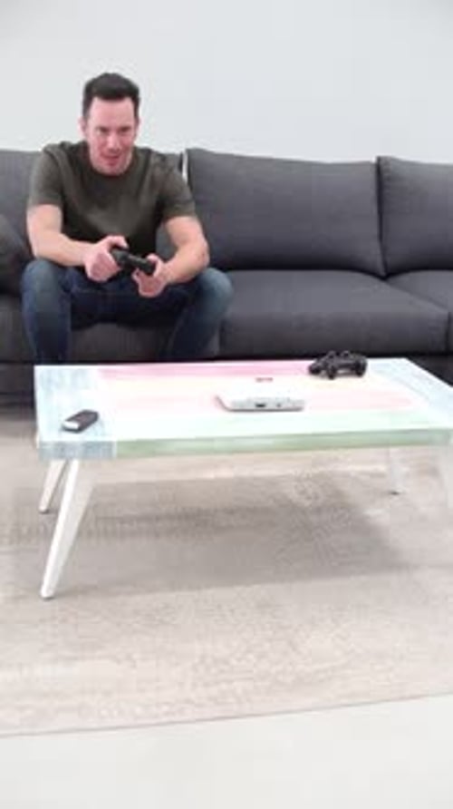 Man Playing Video Game at Home on Couch