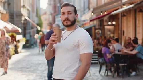 Young Man Guy Enjoying Drinking Morning Coffee Hot Drink Relaxing Taking a Break in City Street