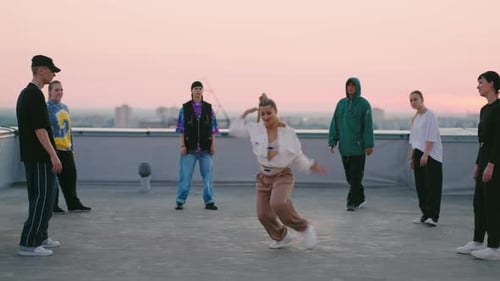 Attractive Young Lady is Dancing Sexy Dancehall Dance on Roof Party of Youth in Summer Hiphop