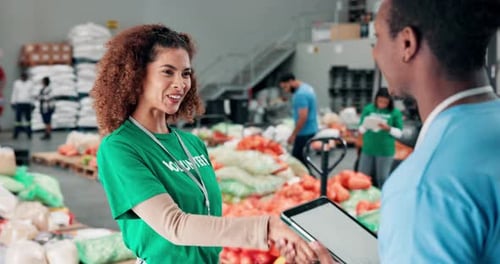 Happy people, volunteer or handshake with tablet for charity help or assistance at NGO warehouse