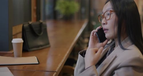 Young Adult Talking On Phone in Office Setting