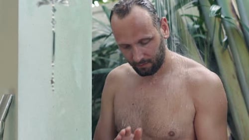 Man Applying Body Wash in Tropical Outdoor Shower