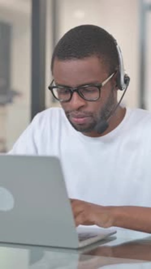 African American Man with Headset Working in Call Center, vertical video