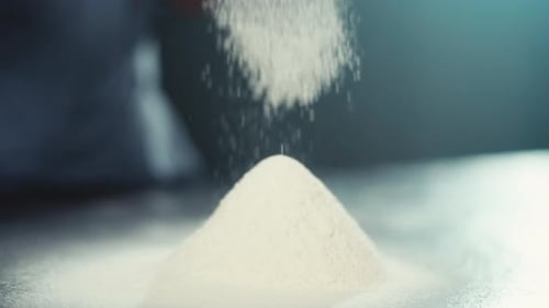Slow Motion Closeup Video of Sifting Flour Through a Sieve