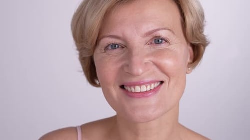 Smiling Woman Holding Cotton Pad Close Up