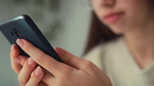 Detailed close up of hands holding and browsing the internet on the phone. Shot with RED helium came