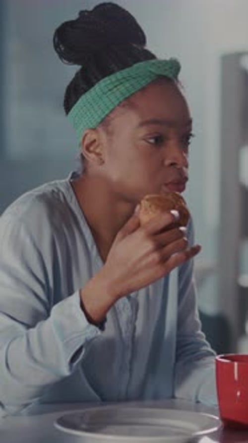 Woman Sampling Flaky Croissant Happily Woman with Green Headband Enjoys Flaky Pastry in Her Warm