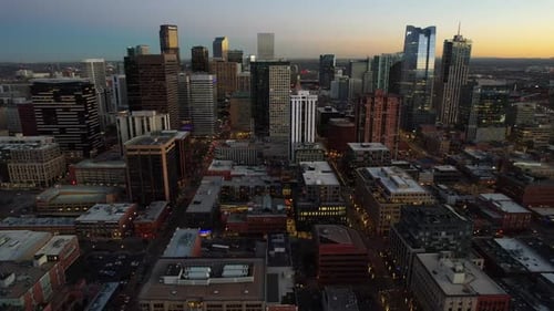 Aerial over the Denver skyline at dusk, Colorado, USA. Drone dolly back shot