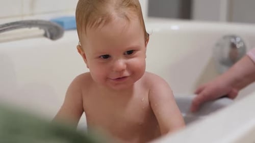 Happy Baby Splashing in the Bathtub