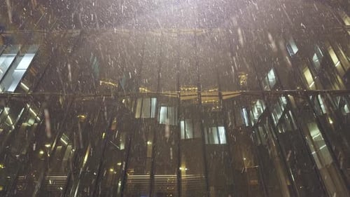 Glass Atrium of a Business Center During Heavy Snowfall at Night in St Petersburg Russia