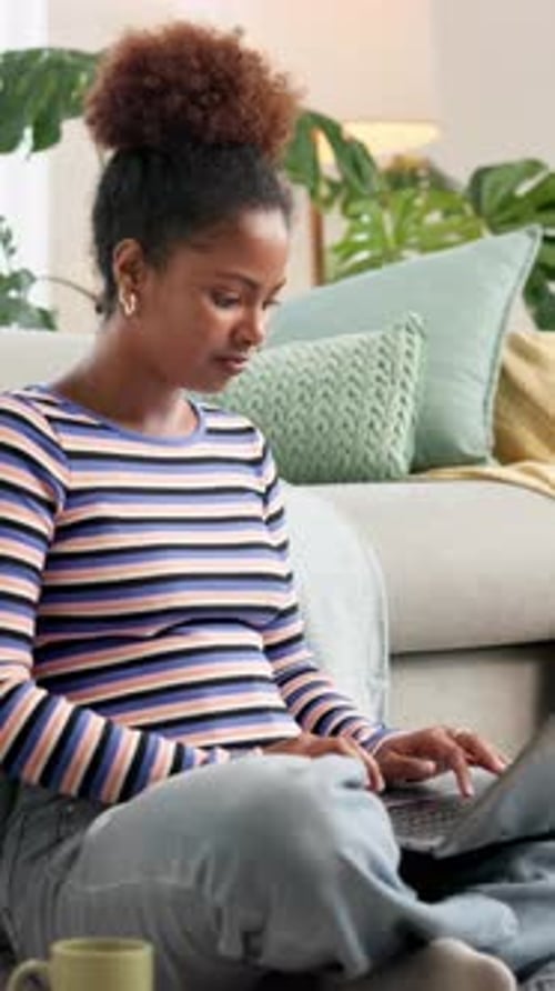 Woman Using Laptop Sitting on Floor at Home