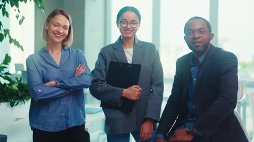 Diverse Business Team Smiling in Modern Office Environment
