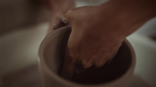 Hands Shaping Clay on Potter's Wheel, Close Up