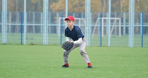 Portrait of a Boy Baseball Player on a Blurry Background the Pitcher Waiting for a Flying Ball