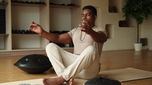 Man Meditating and Breathing in Brightly Lit Studio