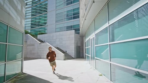 Man Running Urban Street in Headphones Closeup Active Guy Checking Smartwatch