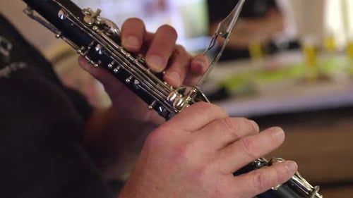 Close-up of hands playing a clarinet