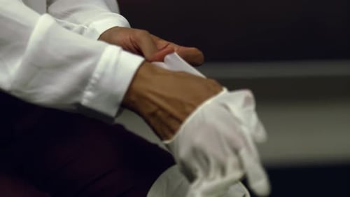 Close up of doctor or nurse putting on latex gloves for virus protection - isolated