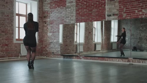 Elegant Woman Dancing in Modern Studio