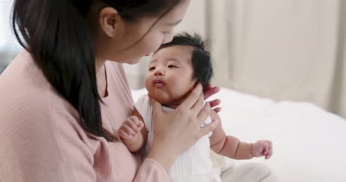 Woman Holds Infant, Indoor