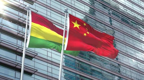 Bolivia and China Flags Waving on Corporate Building