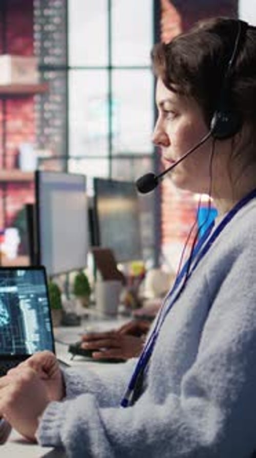 Woman Works Late at Computer in Urban Office