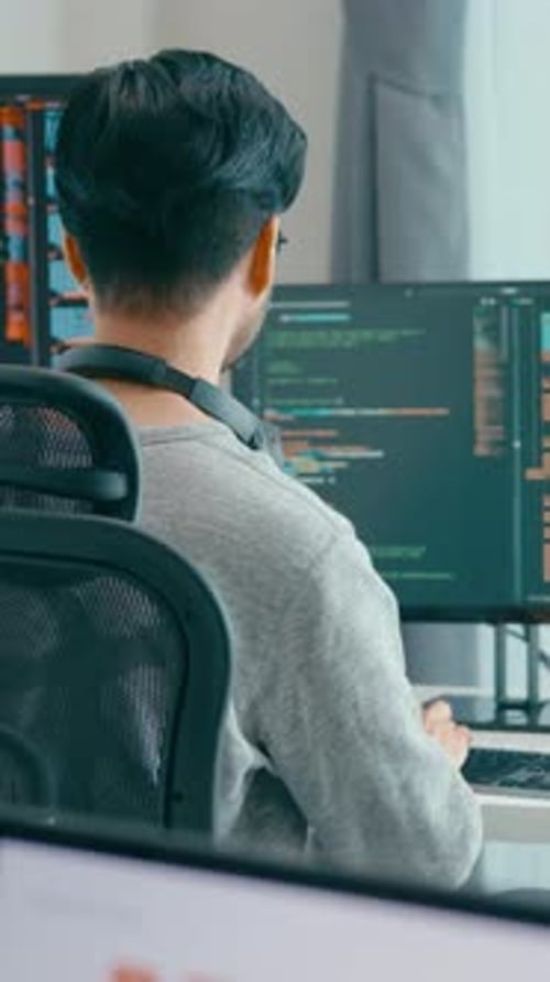 Young adult Asia male freelance eyeglasses typing write prompt AI coding on desktop computer.