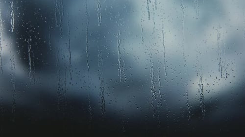 Realistic Rain Drops on Window Pane with Dark Stormy Sky