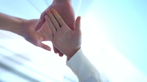 Team huddle business work joining hands committed to mission concept business team putting hands on