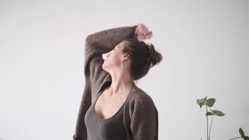 Woman Stretching and Moving Arms Indoors Daytime
