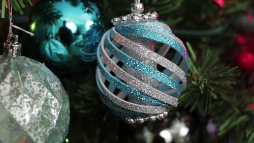 Glittery Christmas Ornaments Hanging on Artificial Tree