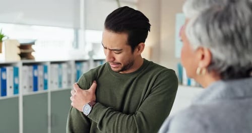 Man Consults Doctor About Painful Shoulder Injury