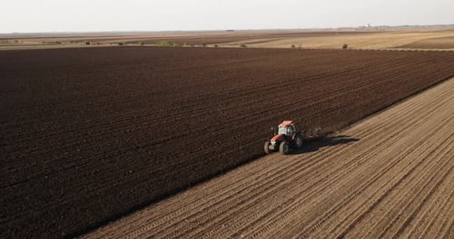 Tractor Plowing Farmland Fields From Above
