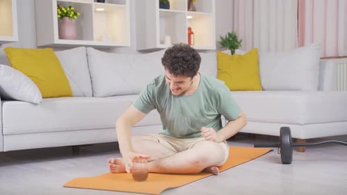 Young Adult Working out at Home on Yoga Mat