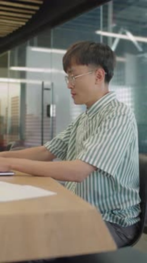 Gen Z Asian Man Working on Laptop in Office