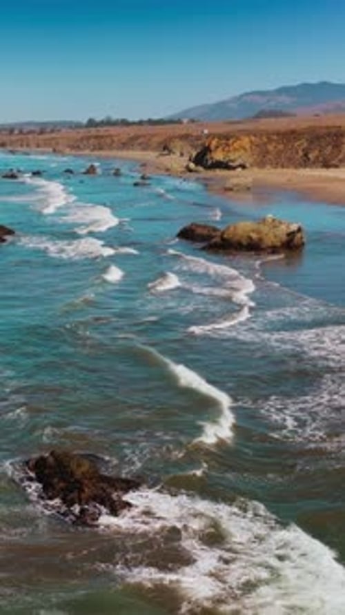 Calming pleasant view of waves moving to the shore. Pacific ocean coastline at Morro Bay, California