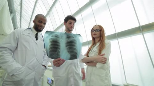 Doctors Reviewing an X-Ray in Hospital Setting