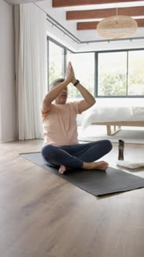 Mature Adult Yoga Pose in Bright Room
