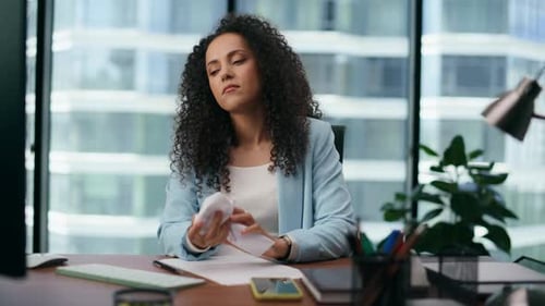 Frustrated Latina Worker Crumpling Paper